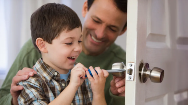 Father and son fixing the door.