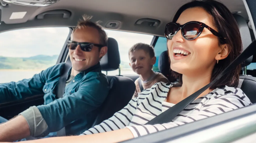 Happy family riding in the car together.