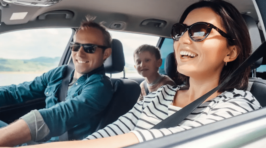 Happy family riding in the car together.