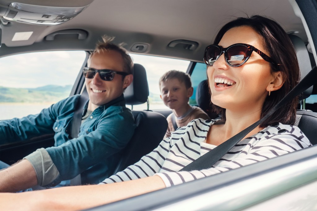 Happy family ride in the car together.