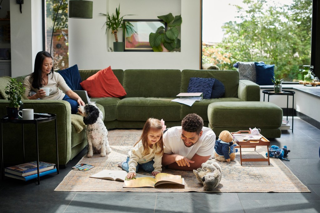 Family of three spending time together in the living room.